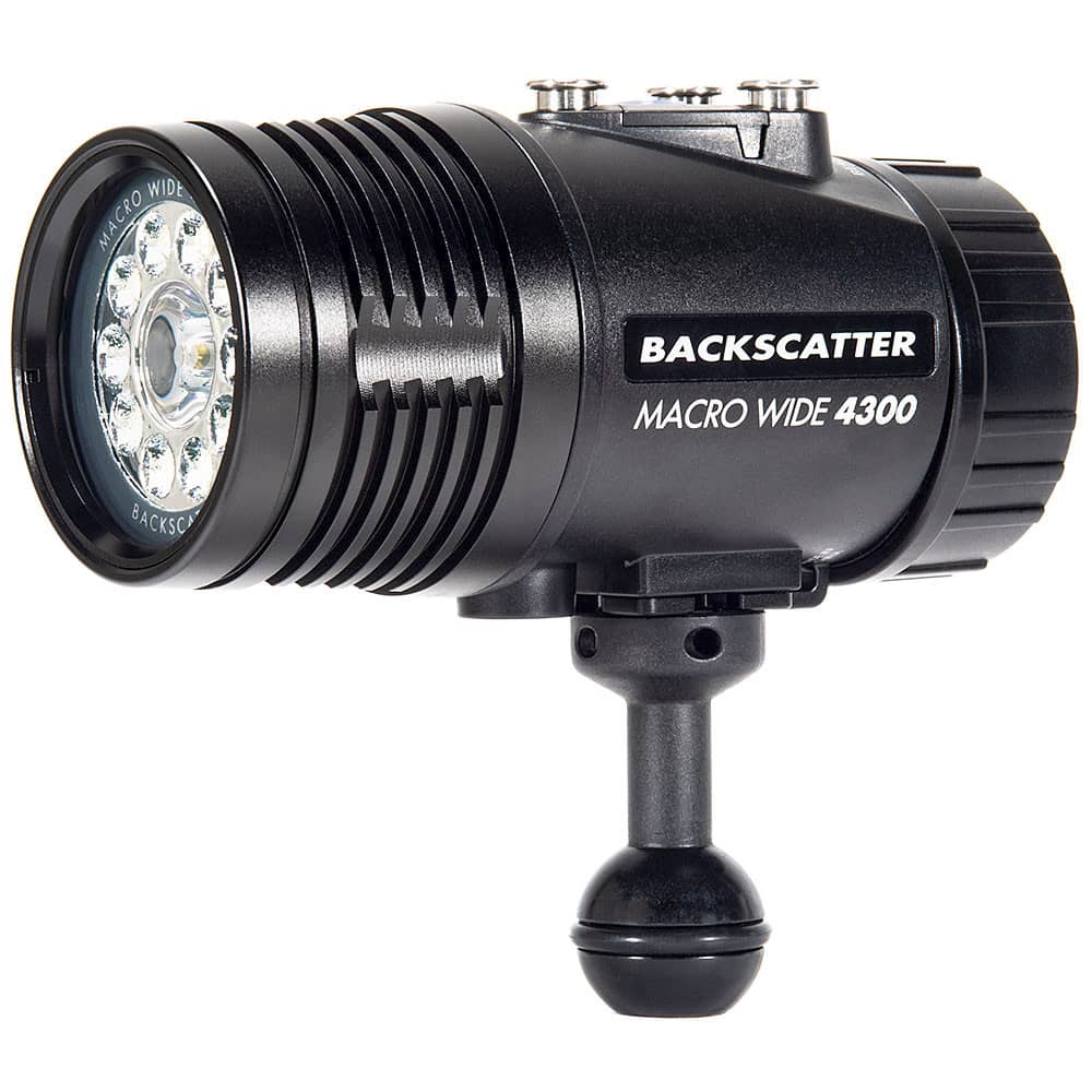 Close-up of the Backscatter Macro Wide 4300 Underwater Video Light (MW-4300), showing its black, compact, cylindrical design with multiple LED lights arranged in a circular pattern at the front. The product features branding on the side and a ball mount at the base for easy attachment to underwater camera rigs.